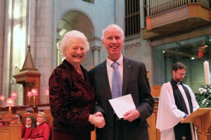 David Mann (Secretary of Lisburn Outlook) receiving a cheque from Dame Mary Peters at Belfast Cathedral (5th February 2017) 